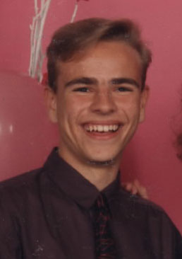 Izzy as a teen with a big wave of hair